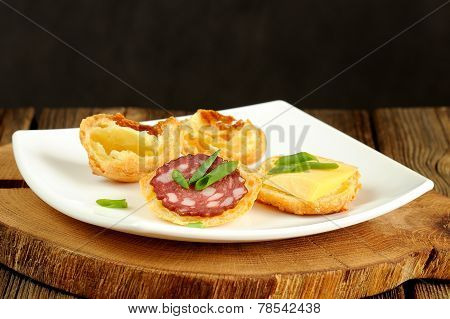 Gougeres With Cheese And Sausage On White Plate