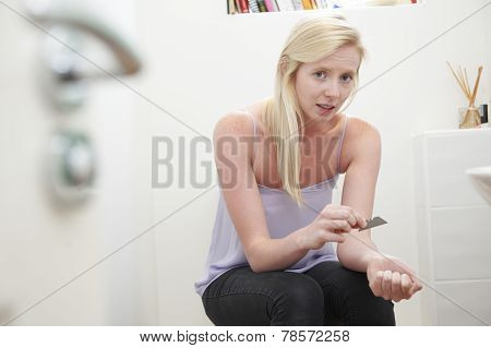 Teenage Girl Self Harming With Knife Blade