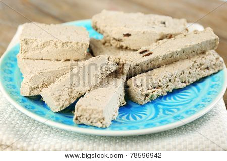 Two kinds of sunflower halva - with raisinas and vanilla taste. on plate, on wooden background