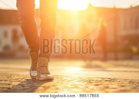 Womansfoots on the street at sunny day.
