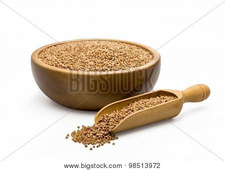 Buckwheat groats in a bowl and wooden scoop
