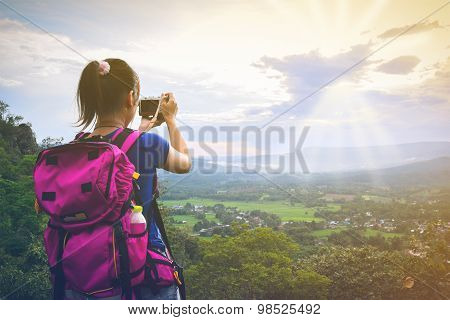 Young Woman Backpack Travel Taking Photographs The Beautiful Landscape Of Mountain In Sunset (vintag