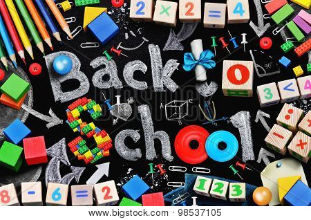 School supplies on black schoolboard background