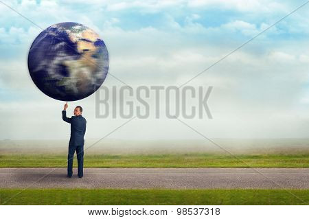 Businessman Holding Planet Earth With One Finger