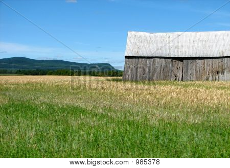 Berge und alte hölzerne Scheune im Feld
