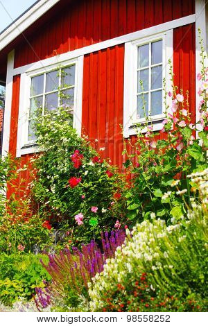 summer cottage with flower in the garden