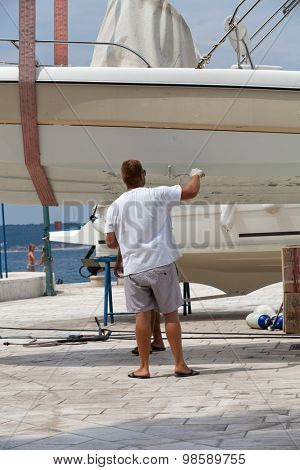 Man painting a boat