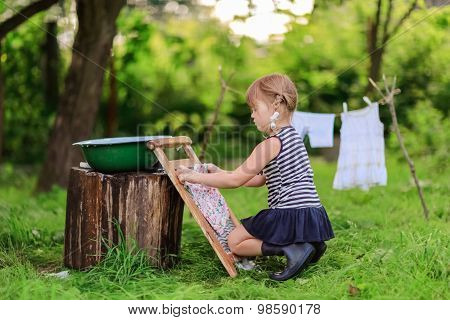 Little Helper Girlwashes Clothes Using The Washboard Outdoors