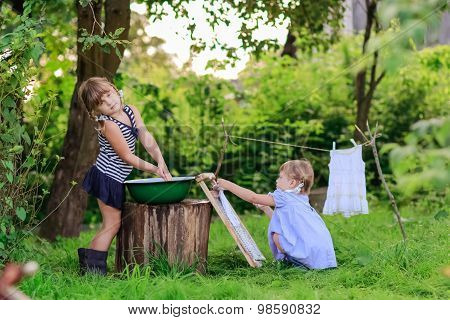 Little Helper Girls Sisters Washes Clothes Using The Washboard Outdoors