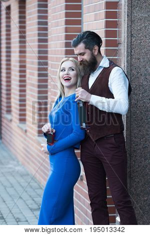 Girl And Man Smiling With Wine And Liqueur Bottles