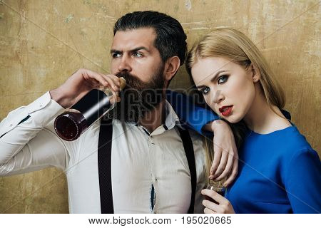 Hipster Drinking Wine From Bottle And Girl Holding Glass