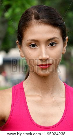 Serious Young Teenage Female Wearing a Pink Shirt