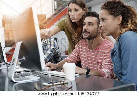 Start-up people working on desktop in co-working space