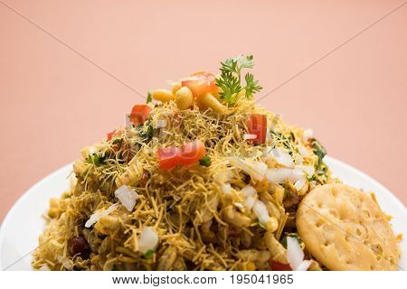 Bhel Puri - Popular Mumbai street food served with coriander and tamarind chutney on white background, selective focus