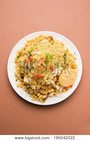 Bhel Puri - Popular Mumbai street food served with coriander and tamarind chutney on white background, selective focus