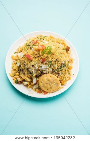 Bhel Puri - Popular Mumbai street food served with coriander and tamarind chutney on white background, selective focus