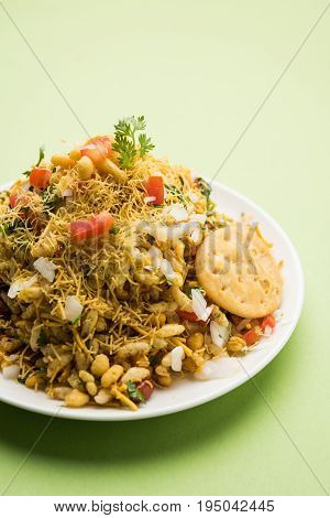 Bhel Puri - Popular Mumbai street food served with coriander and tamarind chutney on white background, selective focus