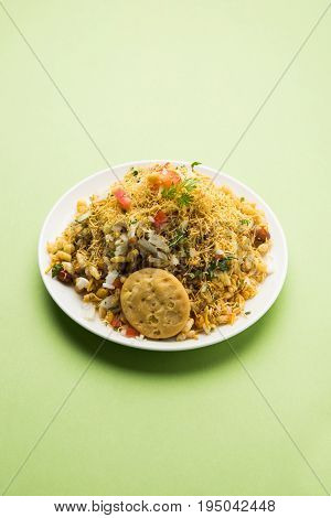 Bhel Puri - Popular Mumbai street food served with coriander and tamarind chutney on white background, selective focus