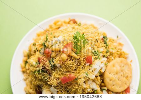 Bhel Puri - Popular Mumbai street food served with coriander and tamarind chutney on white background, selective focus