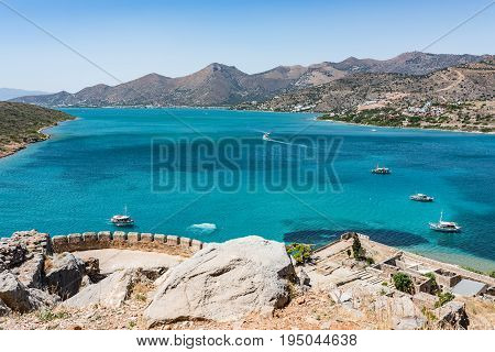 Top Of Spinalonga Island. View To Blue Aegian Sea With Boats, And Mirabello Coast.