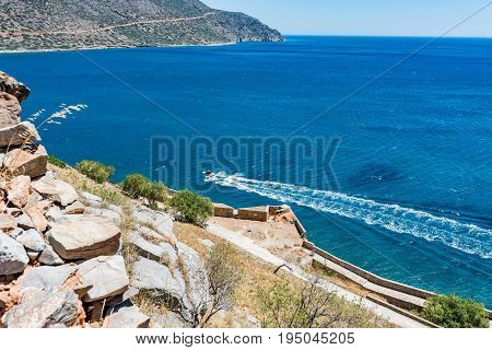 Top Of Spinalonga Island. View To Ruins, Blue Aegian Sea With Boat And Kalydon Island.