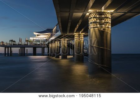 Illuminated pier on the Baltic Sea in Timmendorfer Strand before dusk