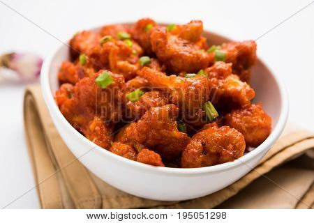 Gobi Manchurian dry - Popular street food of India made of cauliflower florets, selective focus