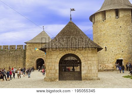 Khotyn Ukraine - 21 May 2017: Tourists walking inside of the Khotyn castle in Ukraine. The castle well is located in the center of the territory.