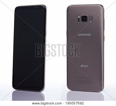 New york, USA - July 11, 2017: New samsung s8+ smartphone isolated on white background. Back and front perspective view of gold Samsung galaxy s8 plus