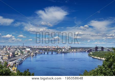 Cityspace of Kiev Ukraine. View on the Dnieper river bank and Podil leading to the two bridges.