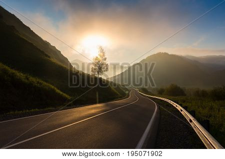 oad in sunrise time Ailai mountains, Russia.