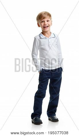 Portrait of happy little schoolboy laughing and holding hands in pockets