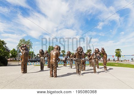 VANCOUVER CANADA - JUNE 25: A-maze-ing Laughter bronze sculpture in Morton Park on June 25 2017 in Vancouver Canada. The installation shows playfulness joy and range of motions in a state of laughter.