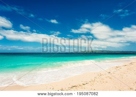 Tropical sea landscape. Beach with white sand and blue sky with clouds nobody. Relax and paradise.