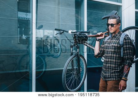 Handsome Young Man With Glasses Carries Bicycle On His Shoulder