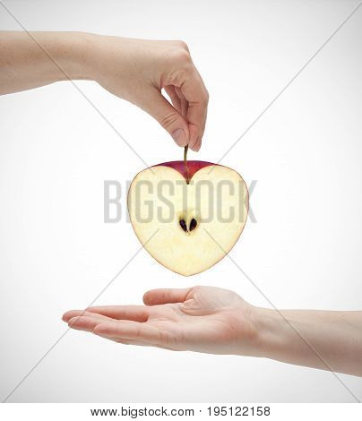 Picture of apples in the shape of hearts and two hands