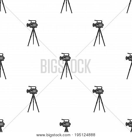 Movie camera on a tripod. Making a movie single icon in black style vector symbol stock illustration .