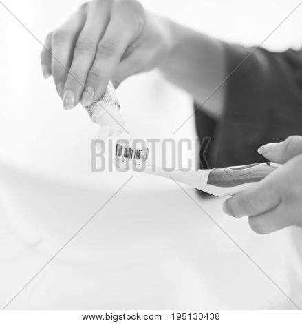 Closeup On Young Woman Squeezing Toothpaste On Toothbrush