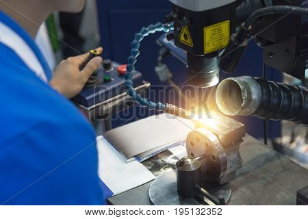 The specialist operator use the laser welding machine.The hi-precision welding process .
