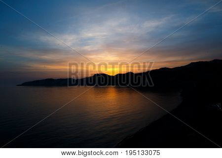Sunset on a beach line with sunset at the front