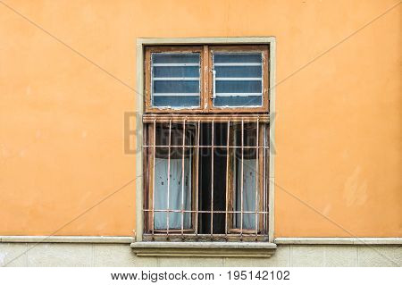 Front view vintage lattice window on a beige wall with scratches