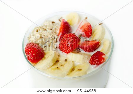 White Yogurt With Strawberry, Banana, Oat Flakes, Flax Seeds On A White Background Sprinkled With Fl