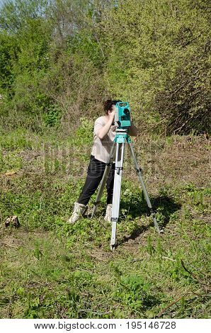 Survey engineer in construction site use theodolite mark a concrete pile co ordinate