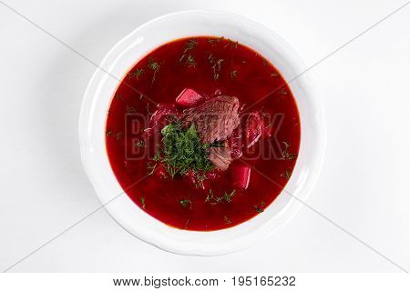 ukrainian soup borsch on white plate. Traditional ukrainian dish borsch isolated on white table, top view. first course