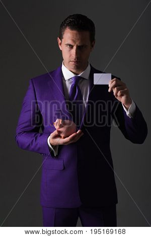 Businessman Holding Piggy Bank And Business Card