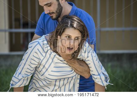 guy making the heimlich maneuver to a girl while she's choking
