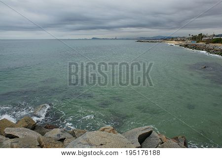 Marine landscape in a cloudy day. A rocky beach