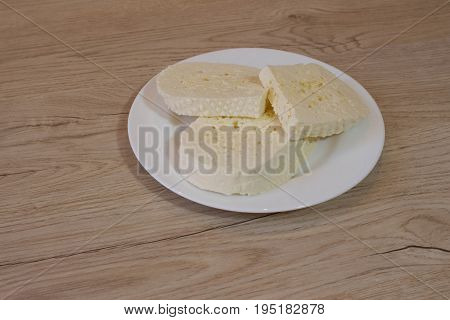 Imeretian cheese Cut on a plate. a traditional white Georgian cheese named Imeretian cheese