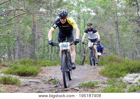 STOCKHOLM SWEDEN - JUNE 11 2017: Group of male mountain bike cyclists in the forest at Lida Loop Mountain bike Race. June 11 2017 in Stockholm Sweden