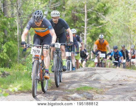 STOCKHOLM SWEDEN - JUNE 11 2017: Group of male mountain bike cyclists in the forest at Lida Loop Mountain bike Race. June 11 2017 in Stockholm Sweden